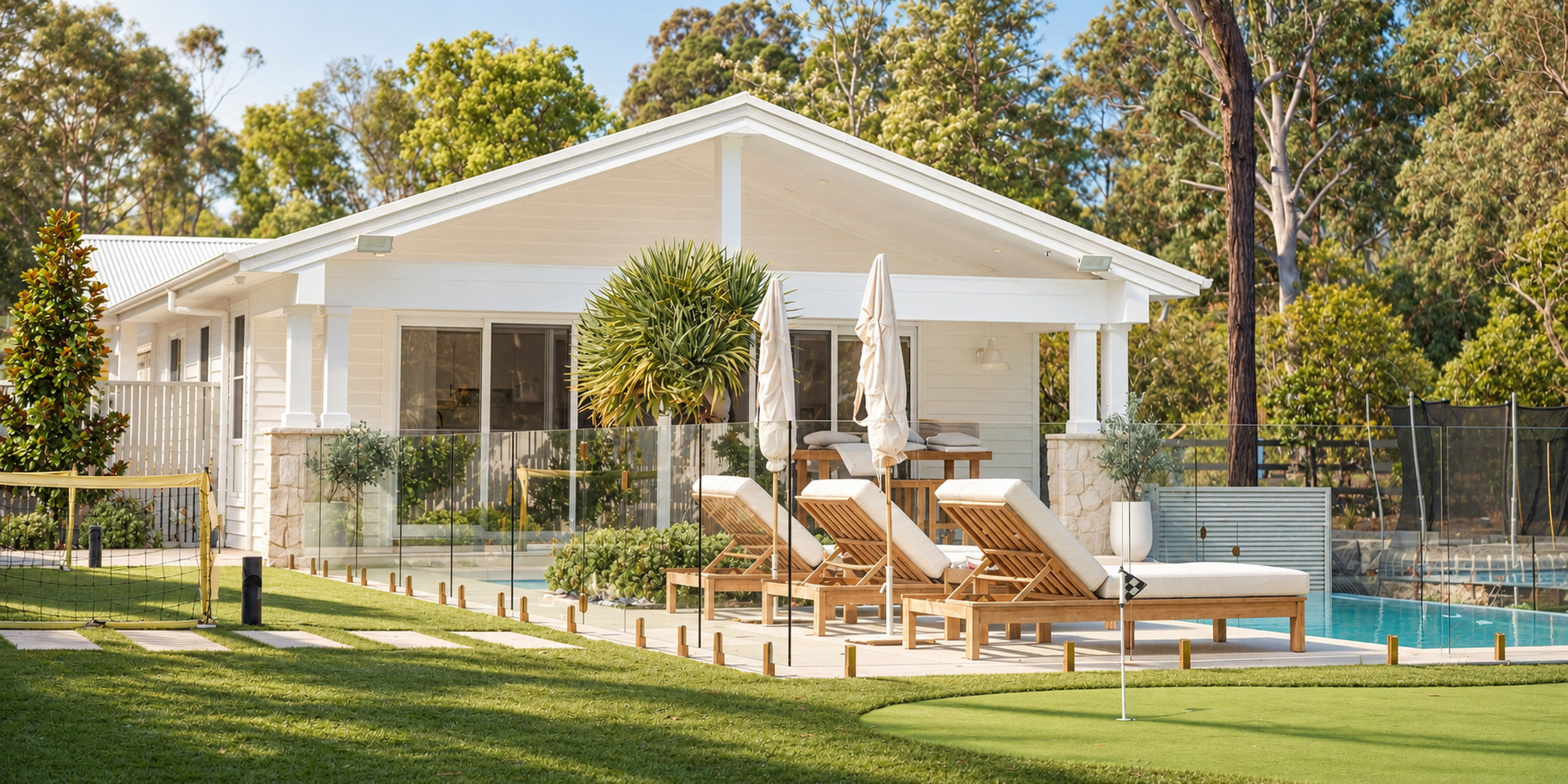 The rear elevation across the lawn, cabana and pool beyond