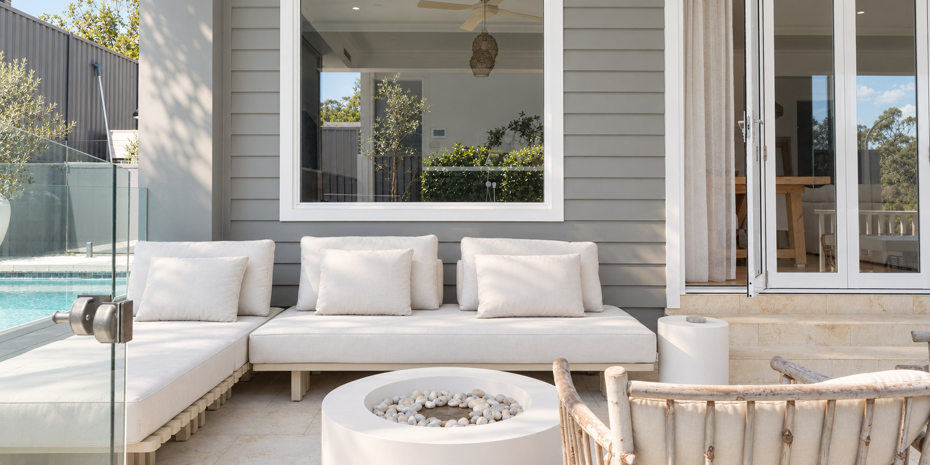 Outdoor lounge and fire pit against the weatherboard