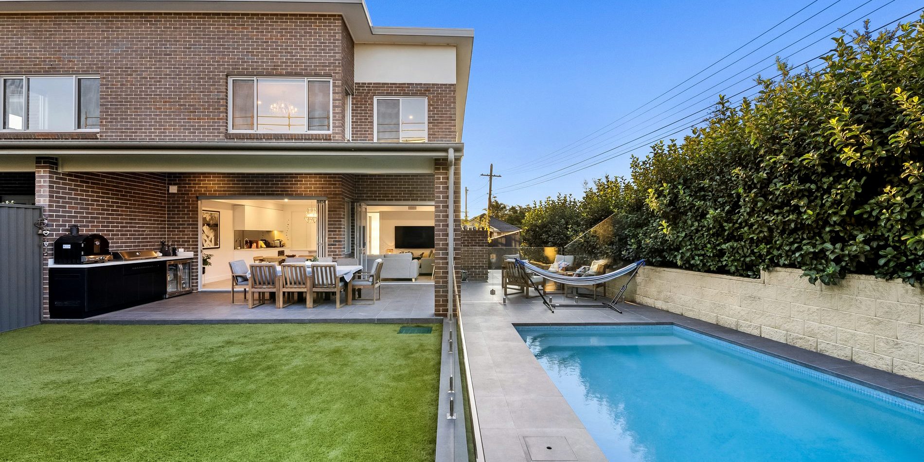 The rear yard, pool and lawn